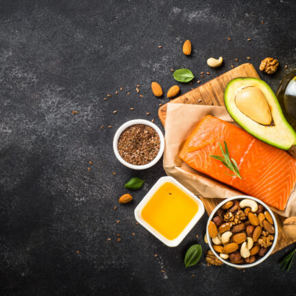 Salmon fillet with avocado, nuts, and oil